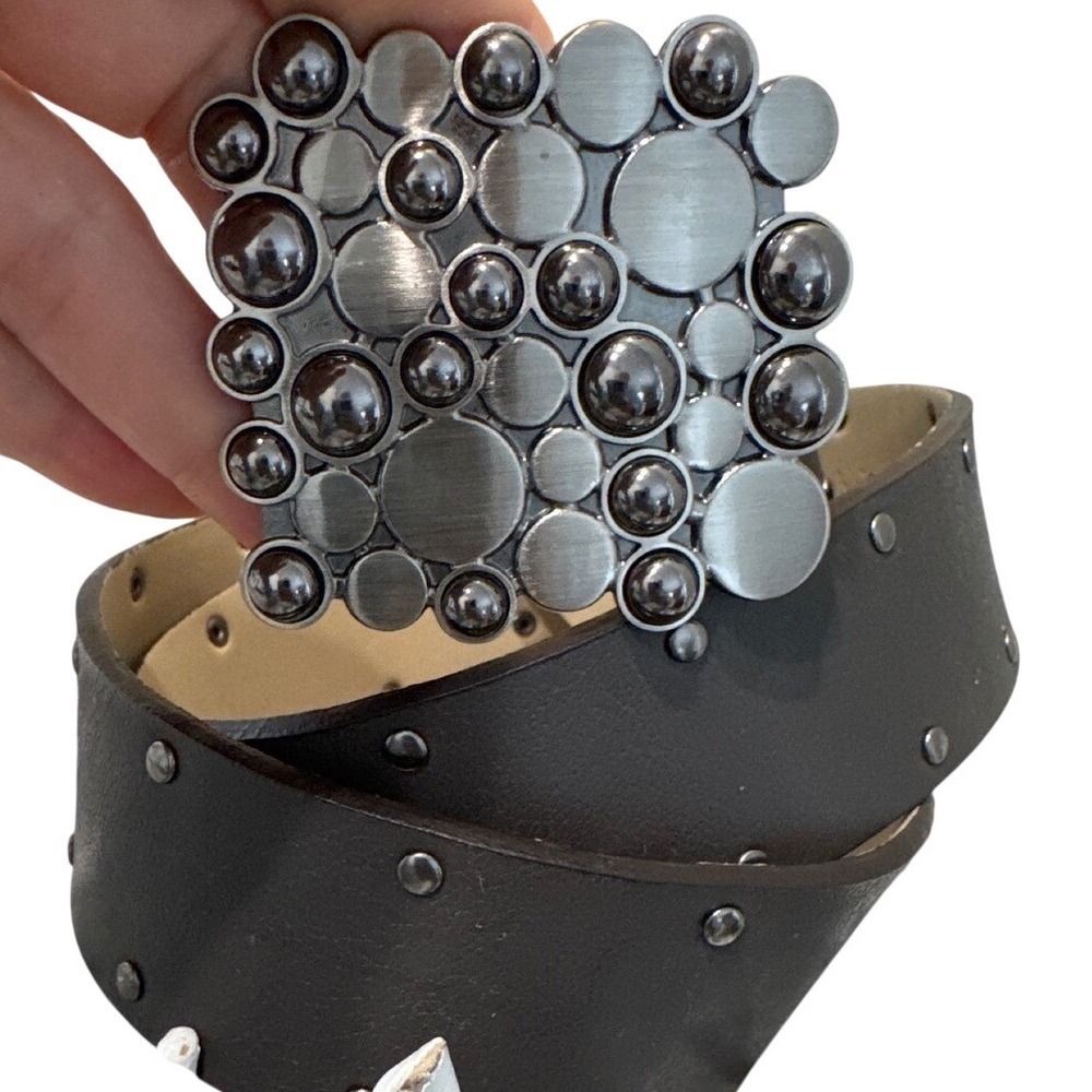 Vintage-style studded leather belt distinctively bold, artistic cluster buckle